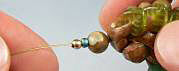 crimp bead next to clay beads on wire